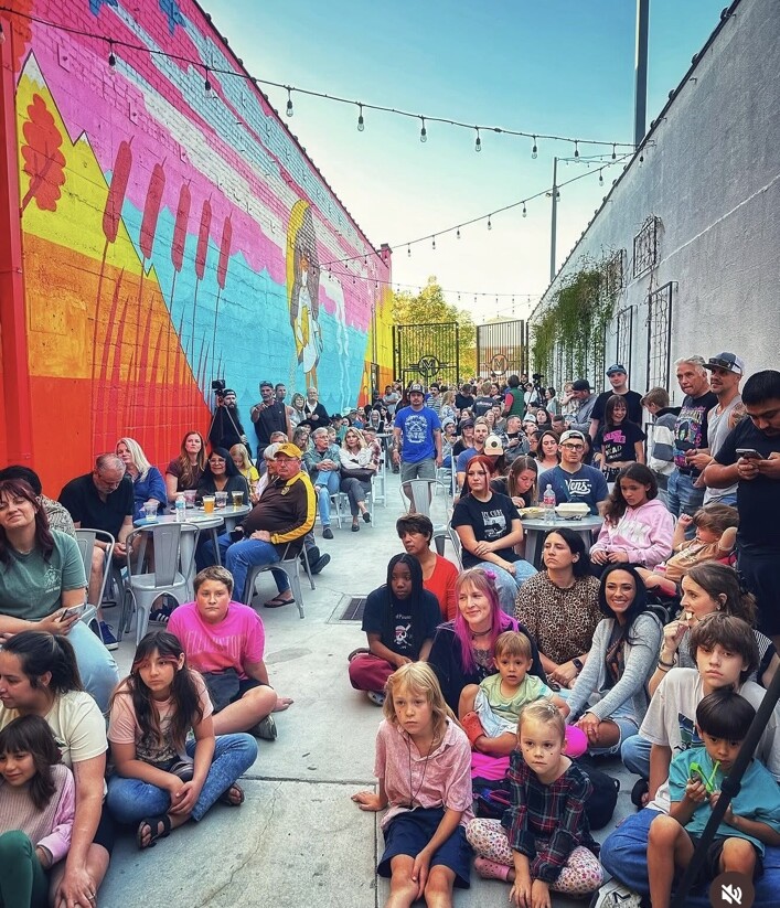 A packed courtyard watching Imagine Music Rock Academy perform at Van Sessions